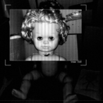 A dingy baby doll stares blankly